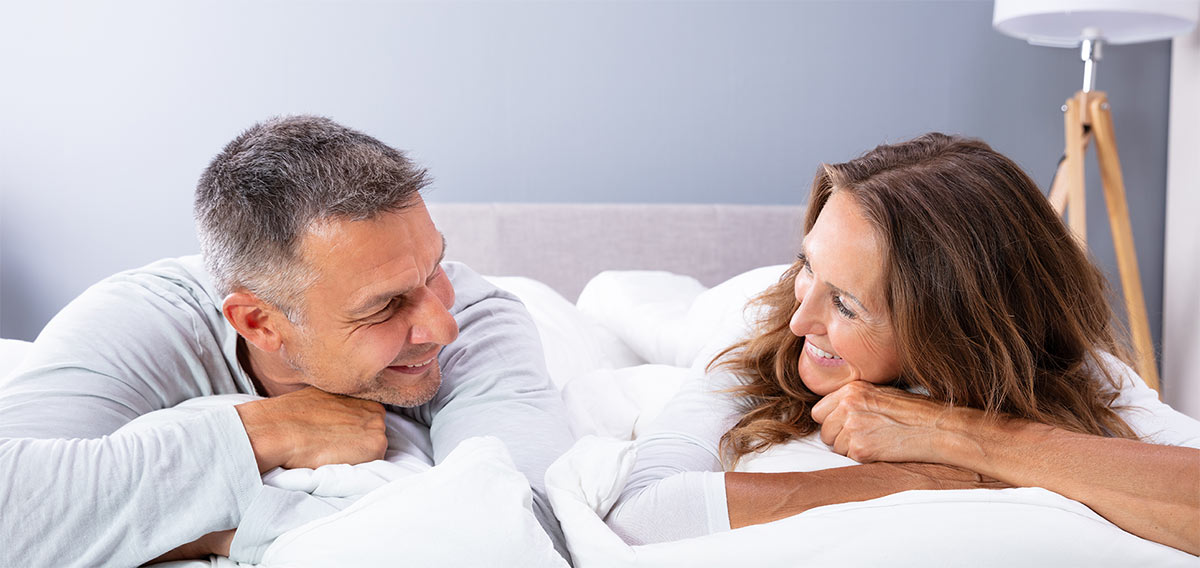 Couple Relaxing On Bed Couple Relaxing On Bed
